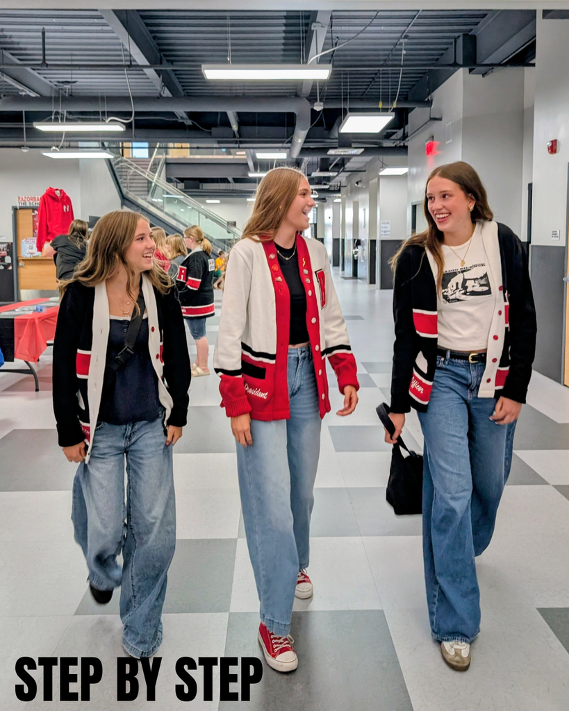 photograph of roy jr leadership walking through the hall talking, 'step by step'
