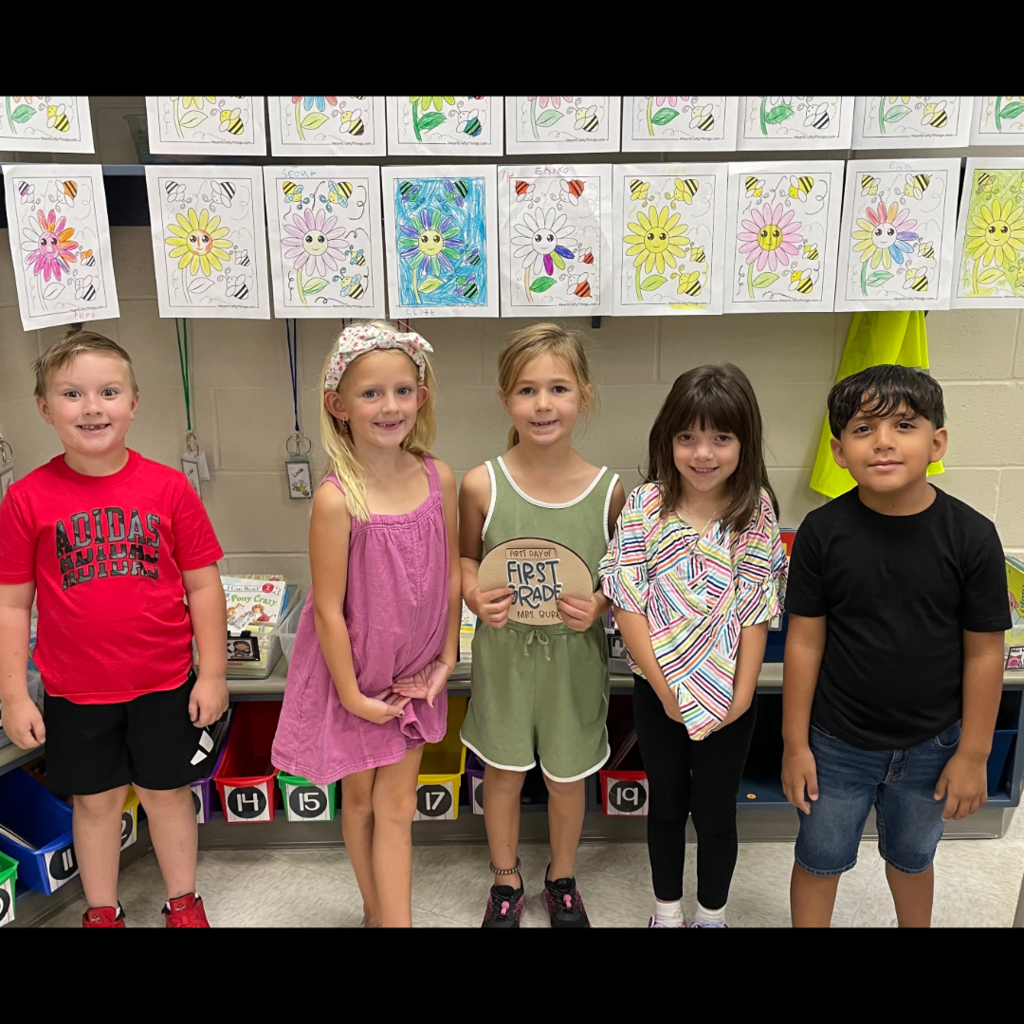 Five students standing in a row.