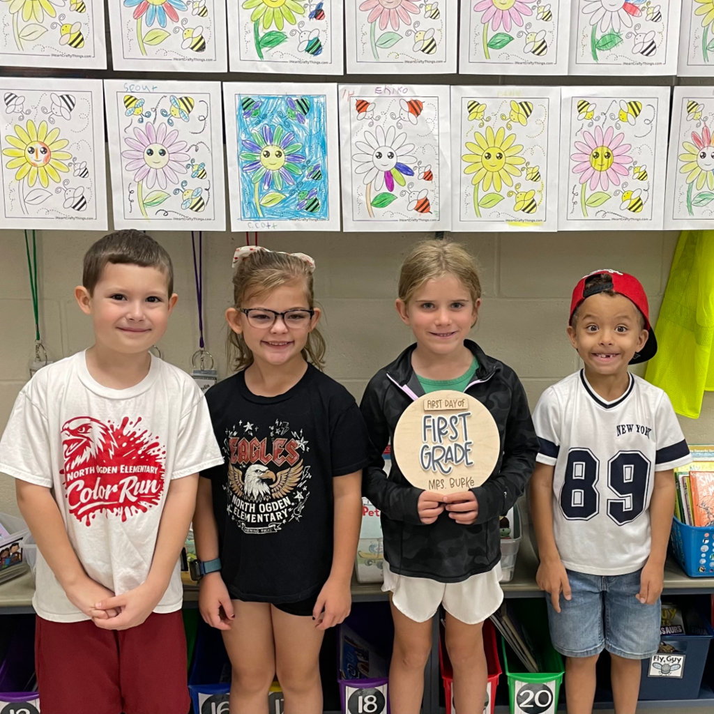 Four students standing in a row.