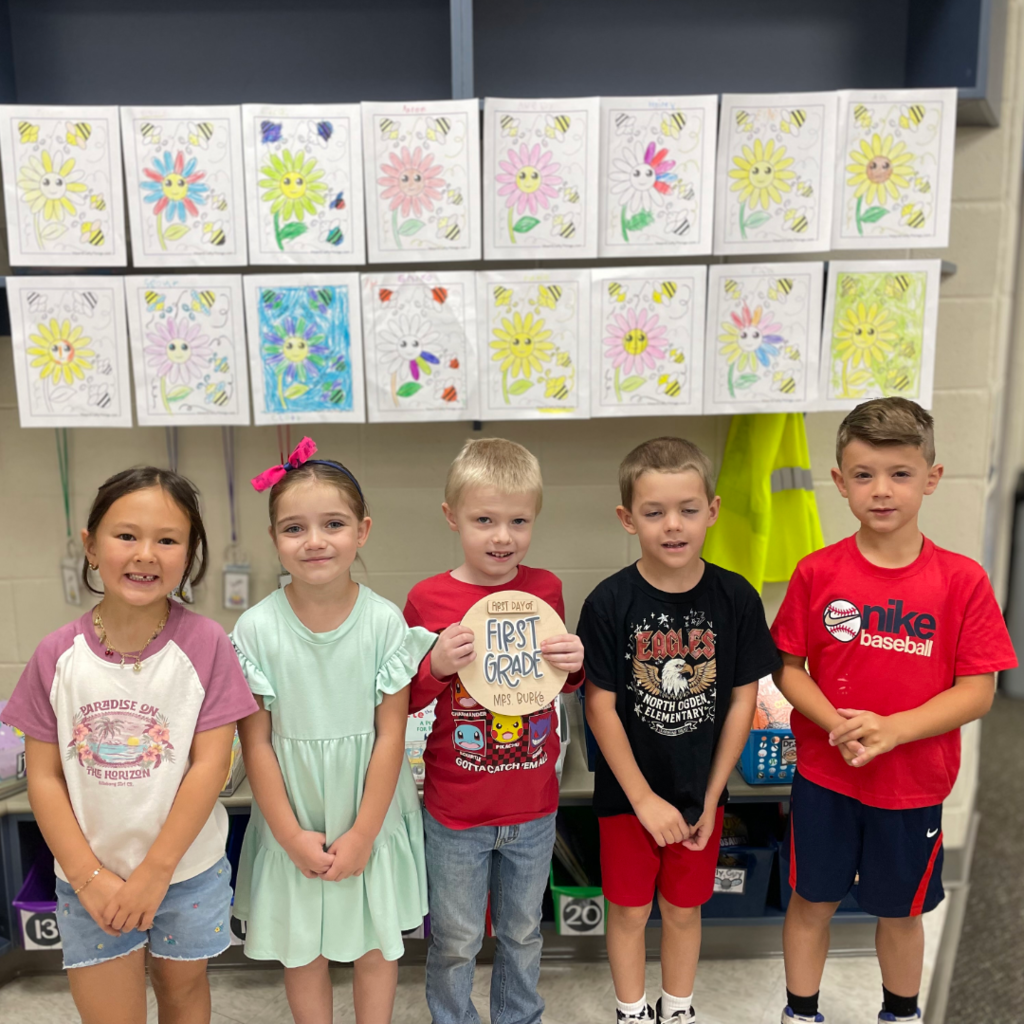 Five students standing in a row.