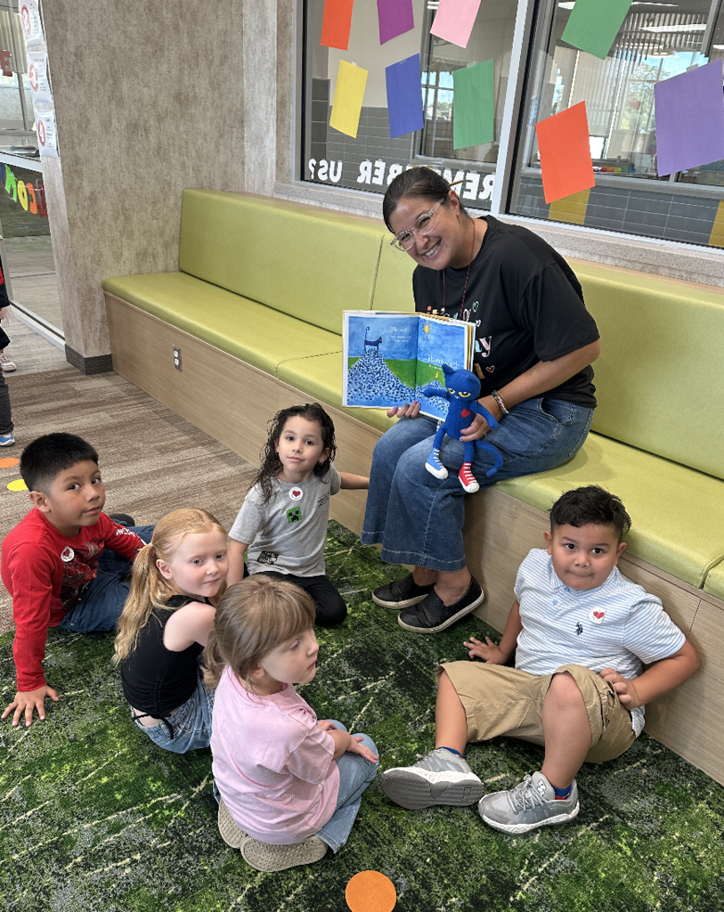 small group of students reading with the librarian