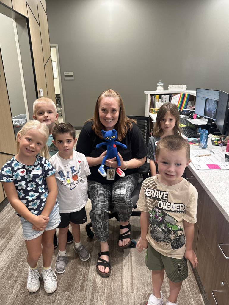 group of students with the administrative assistant