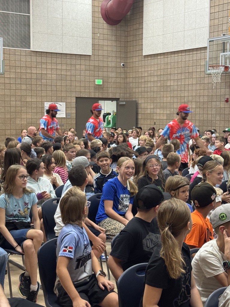 ogden raptors players run in high fiving students along the way