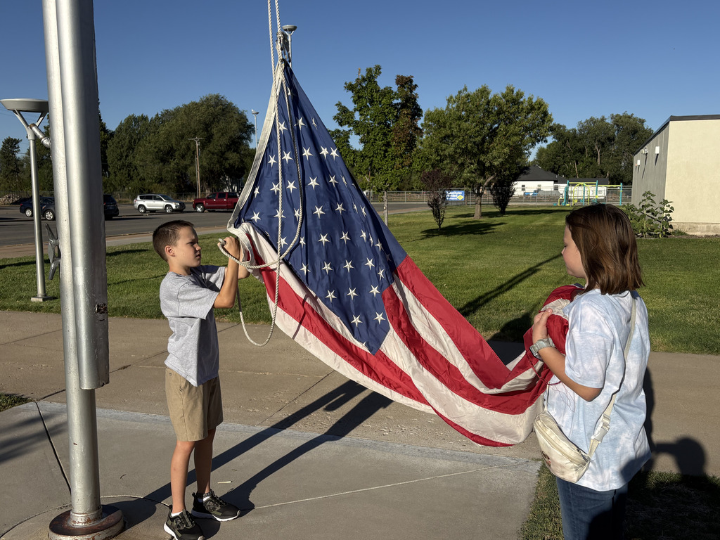 students raising the flag