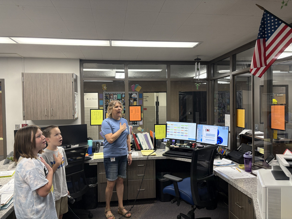 students and staff saying the pledge allegience
