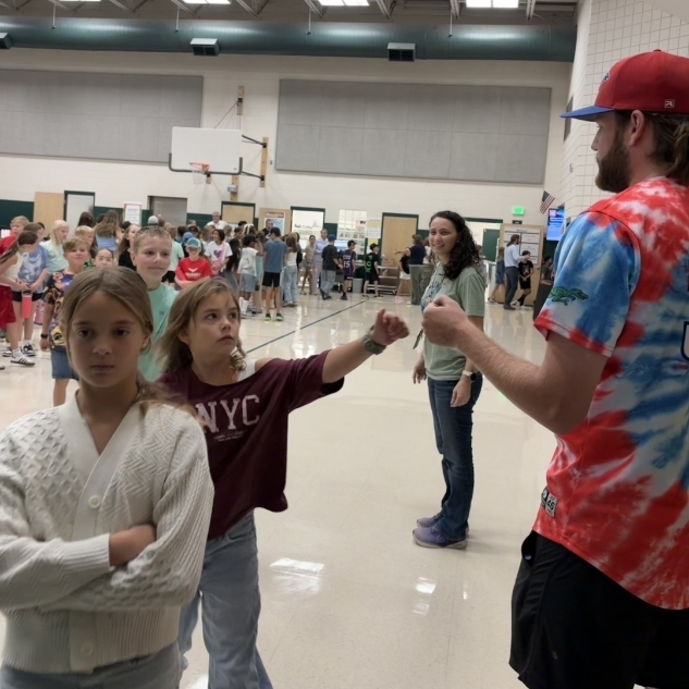 Ogden Raptor team member giving a girl a fist bump
