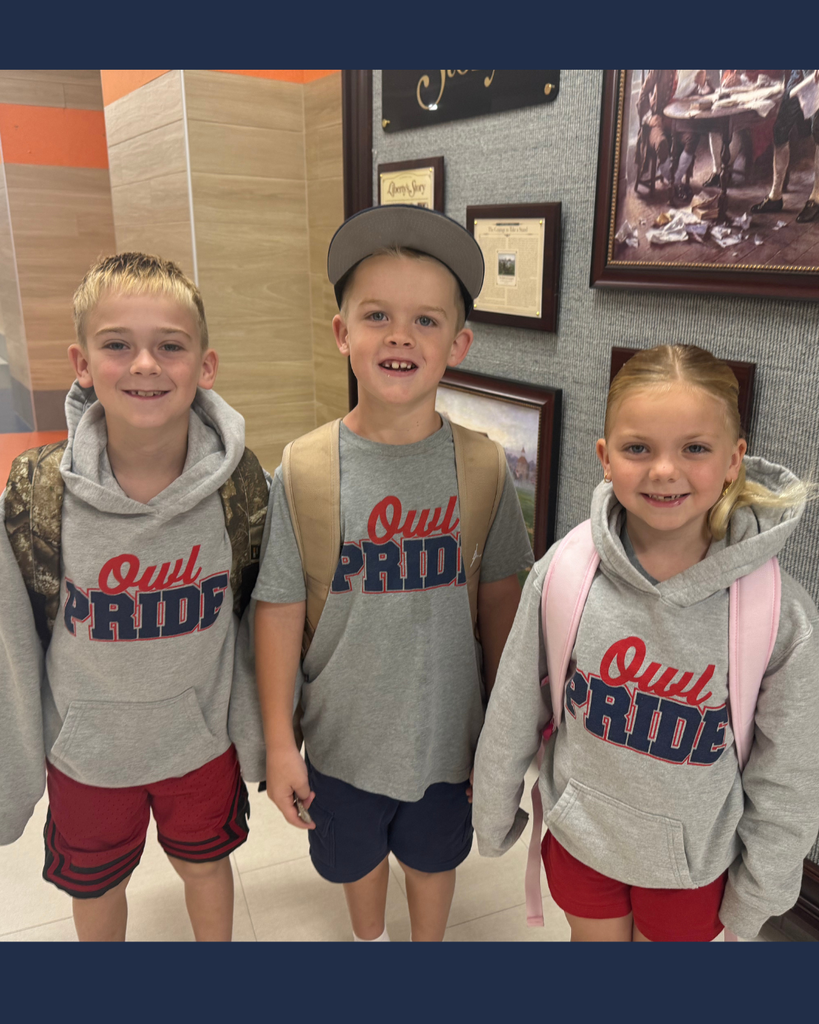 Three student wearing Owl Pride sweatshirst smiling for the camera!