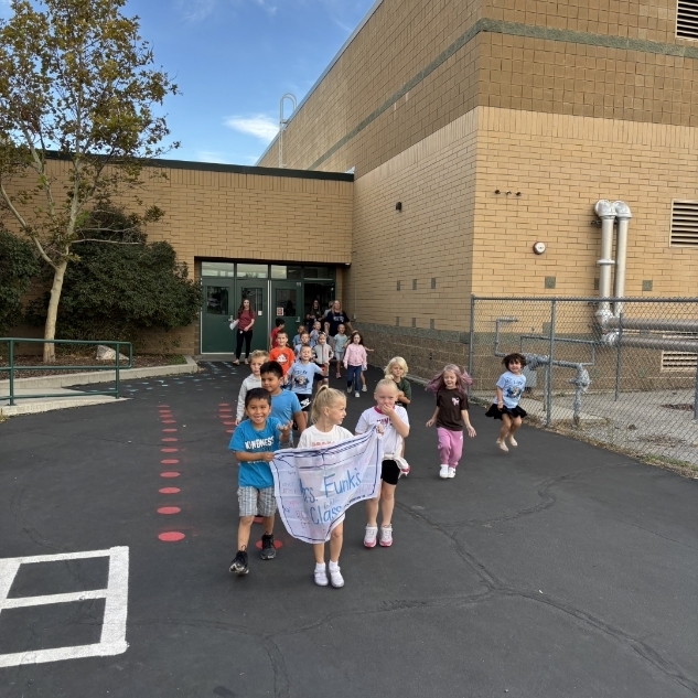 a class of students walking to the fun run