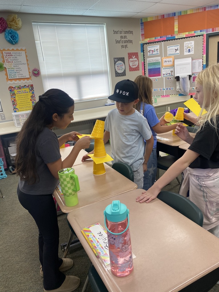 Kids doing an experiment with cups and paper
