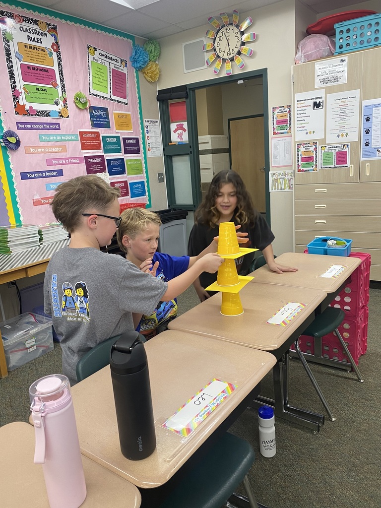 Kids doing an experiment with cups and paper