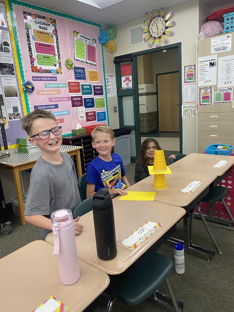 Kids doing an experiment with cups and paper
