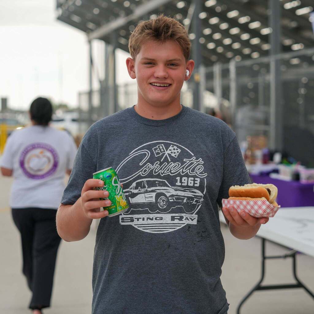 1 boy with a soda and hot dog