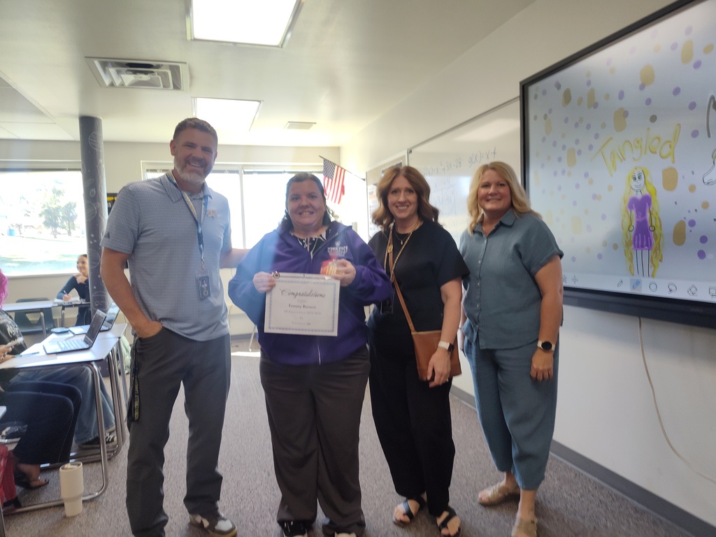 Principal Harris, Mrs. George and Mrs. Baird presenting Ms. Barnett with AP recognition for an incredible pass rate for the 25-26  school year.