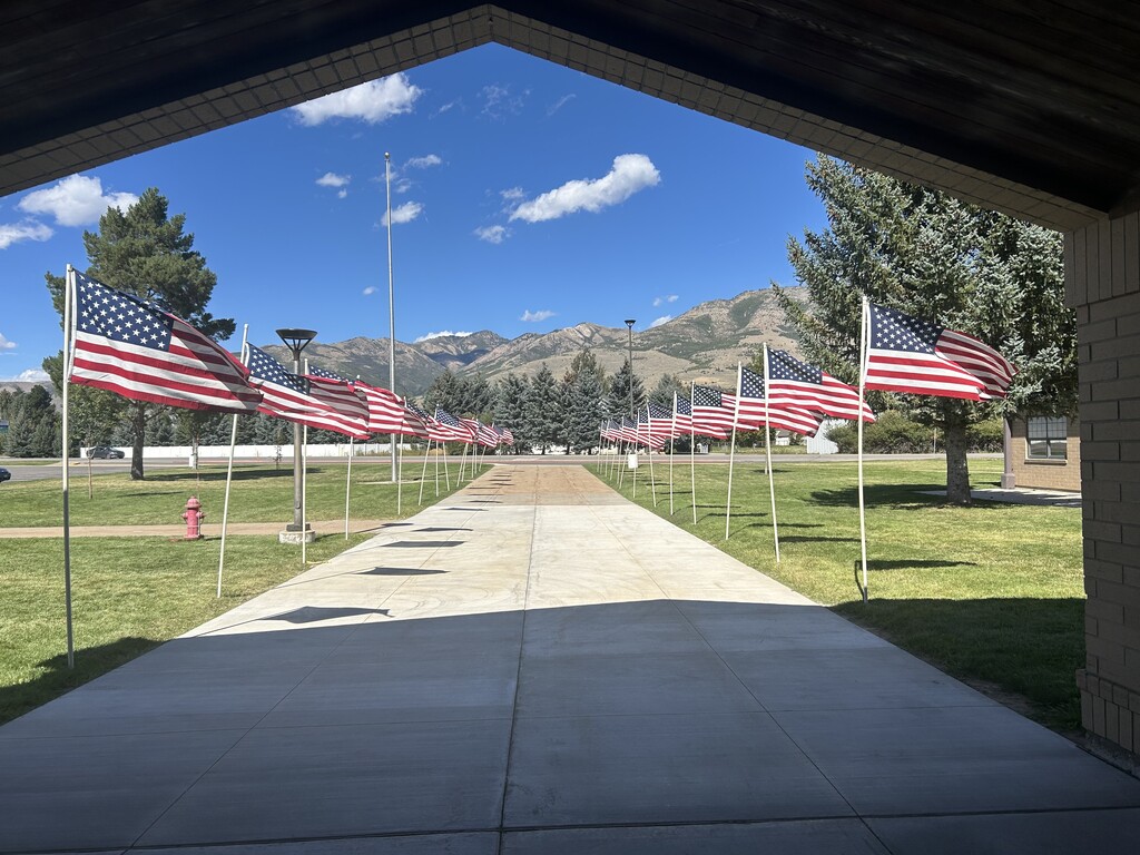 photo of school entrance lined with American flags in remembrance of the 25th anniversary of 9/11