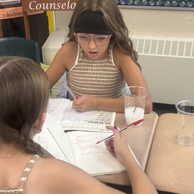 girls writing in notebooks