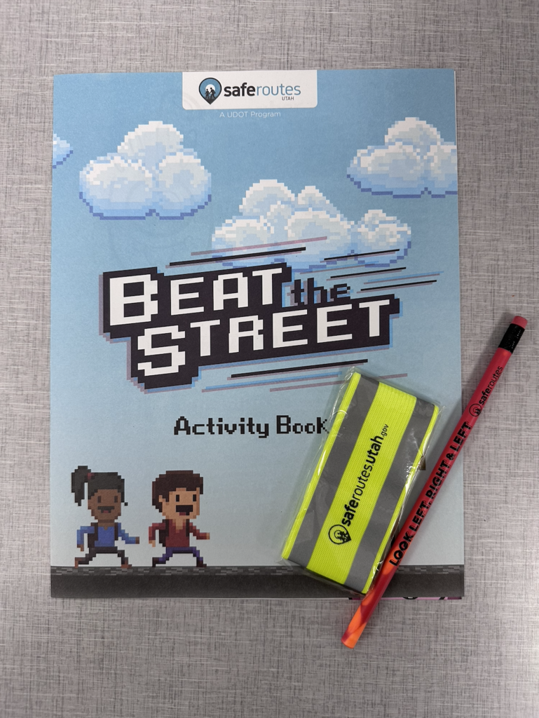 activity book, pencil, and reflective bracelet given to every student by safe routes utah