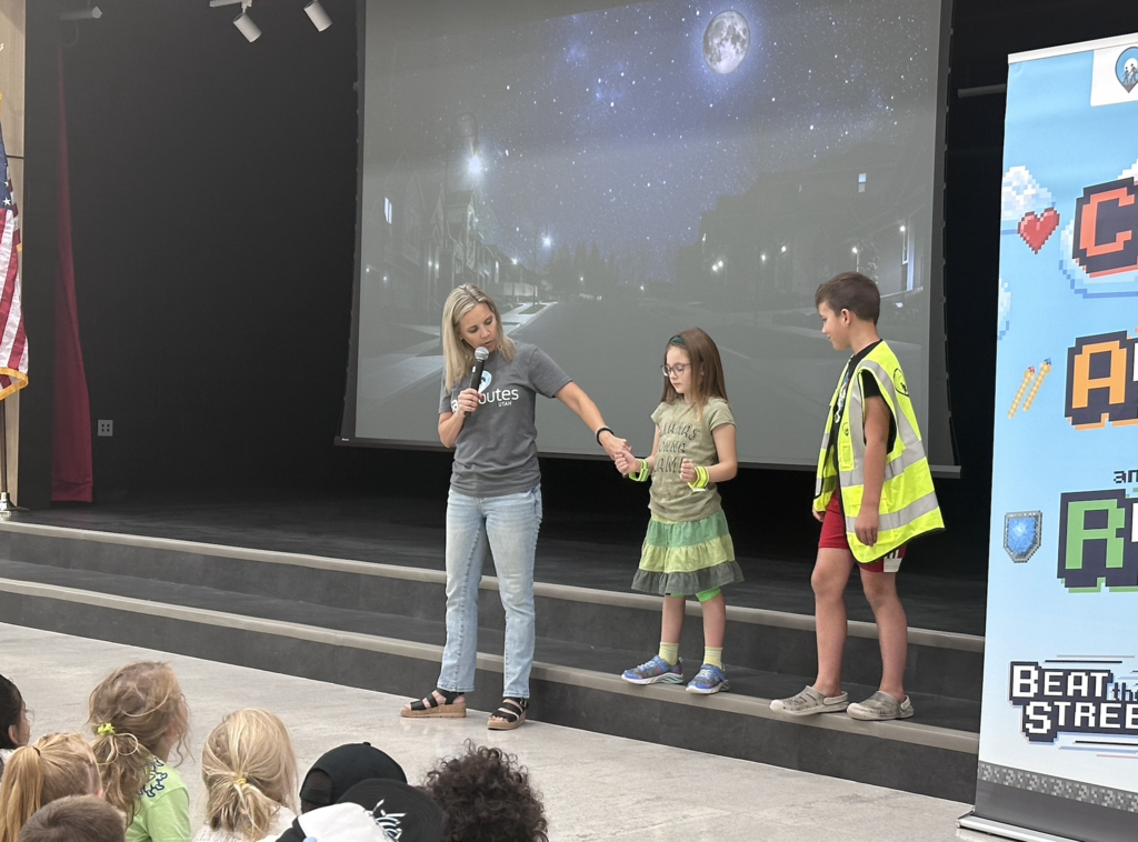 two students helping in the assembly with reflective gear