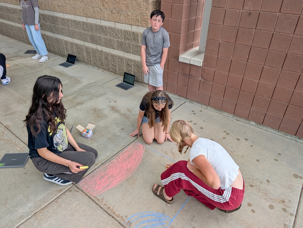 Drawing stars to scale. Outside with chalk for one day and then indoors for day 2. They also studied the colors of a flame and how it relates to stars.