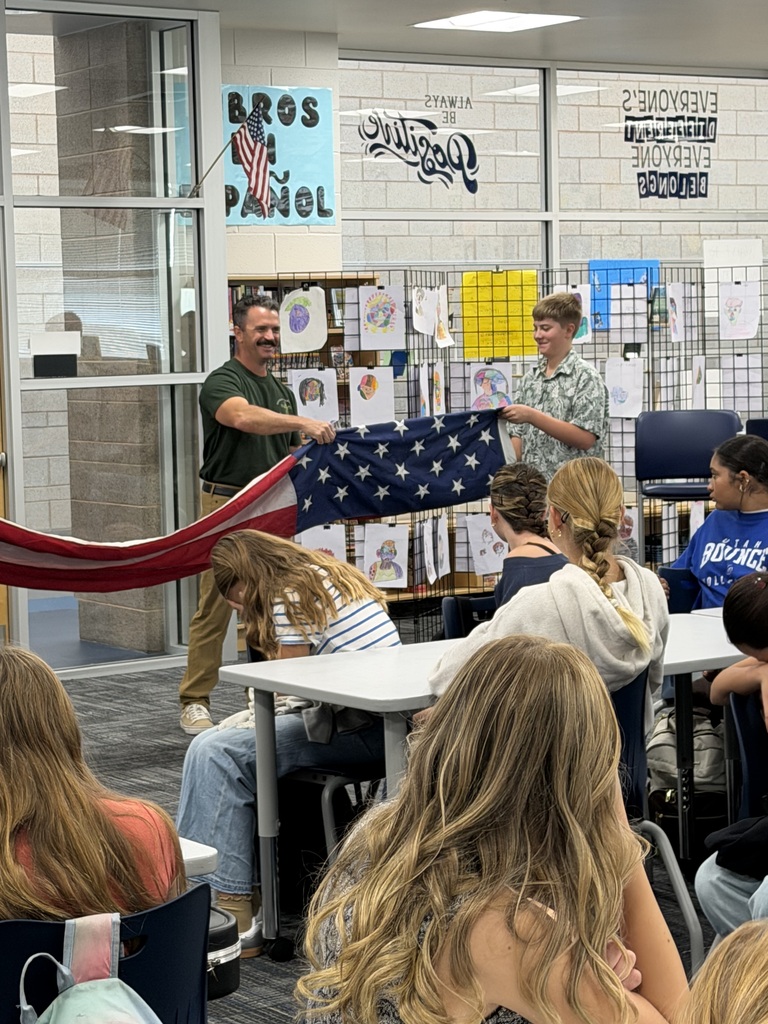 firefighter and students holding flag