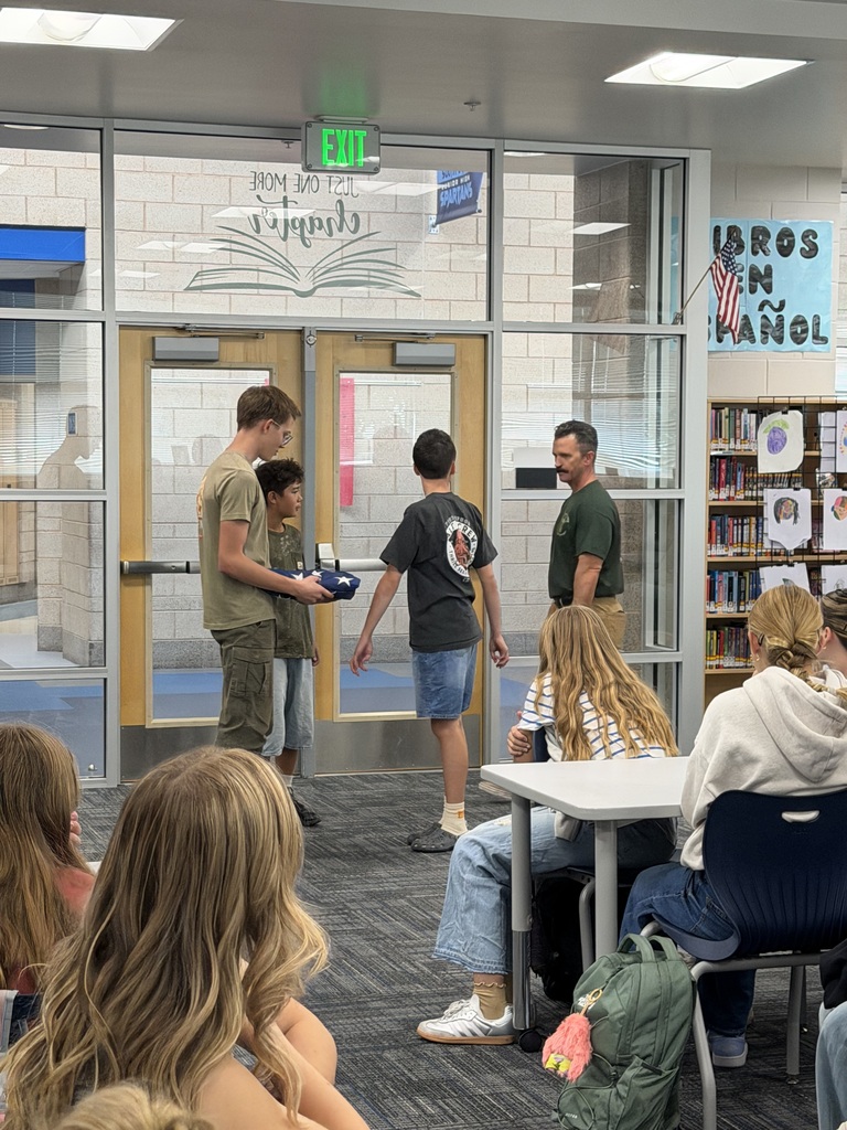 Students and firefighter with flag