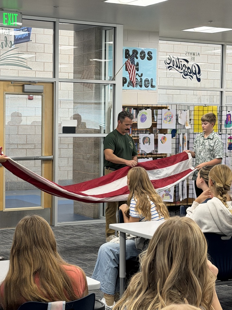firefighter and students holding flag