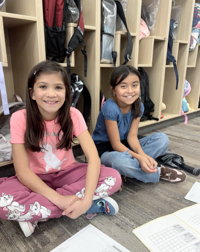 2 girls sitting and smiling