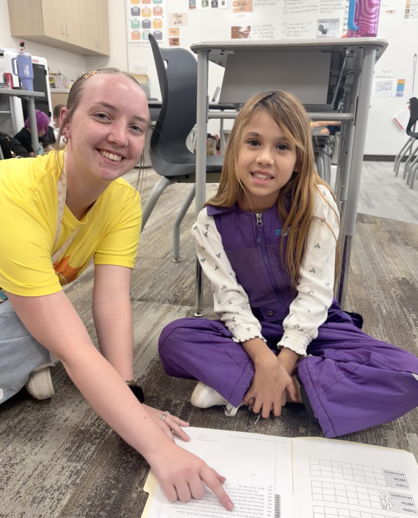 a student reading with a teacher