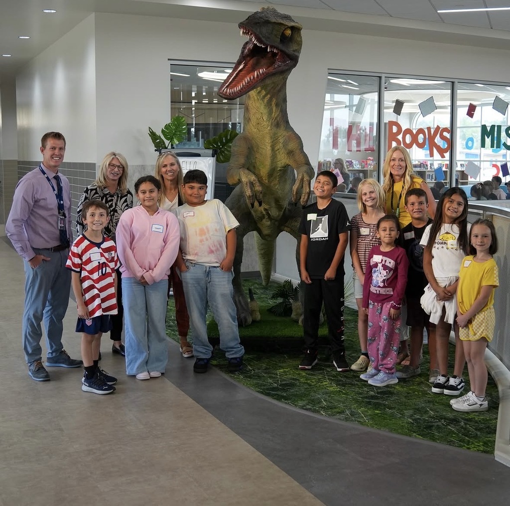 group of student representatives posing with Katy Hall and franklin the raptor