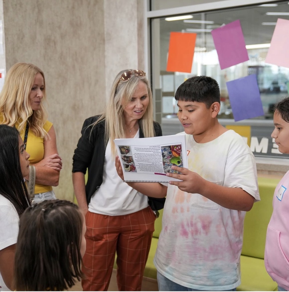 students showing katy hall the book they wrote about Franklin our school mascot