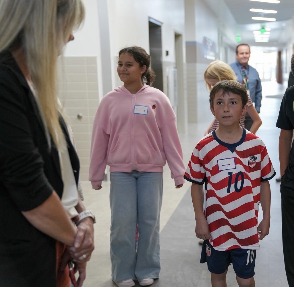 students showing katy hall around the school