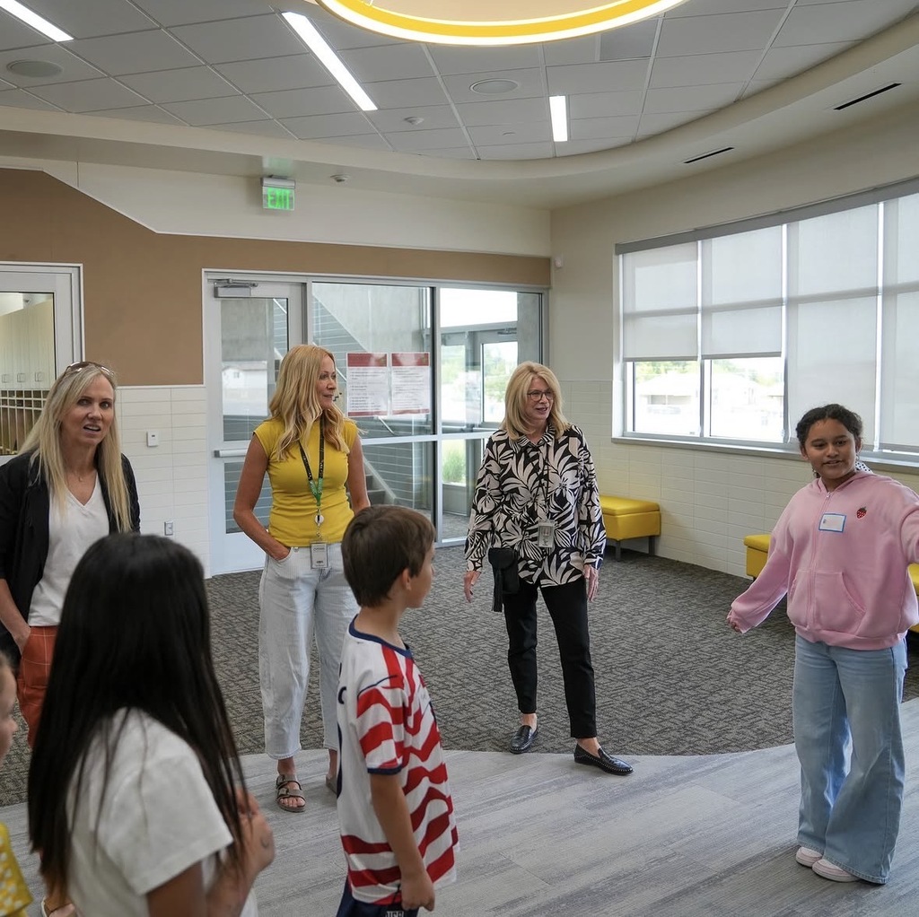 students showing katy hall around the school