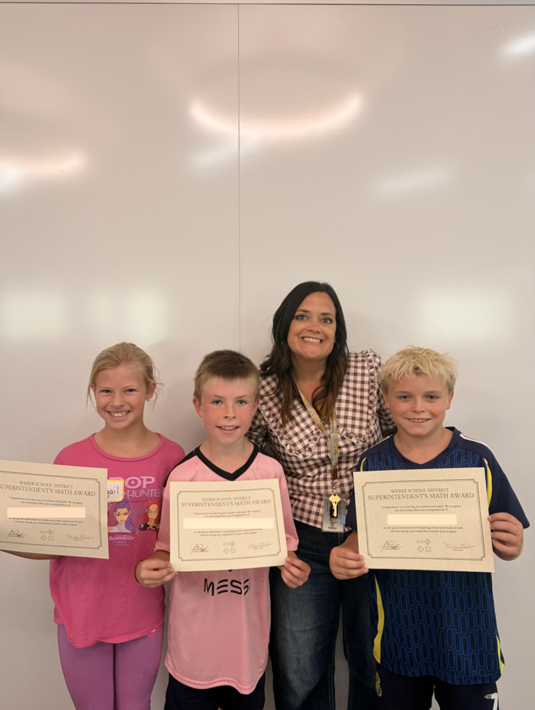 a groups of 4th grade students holding their awards with their teacher