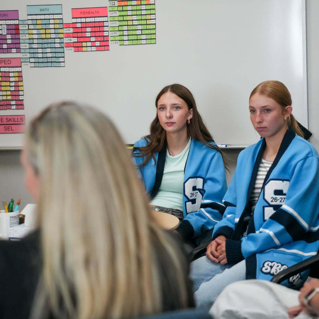 Representative Katy Hall sits in on a small group discussion with South Ogden Junior High Student Body Officers in a conference setting.