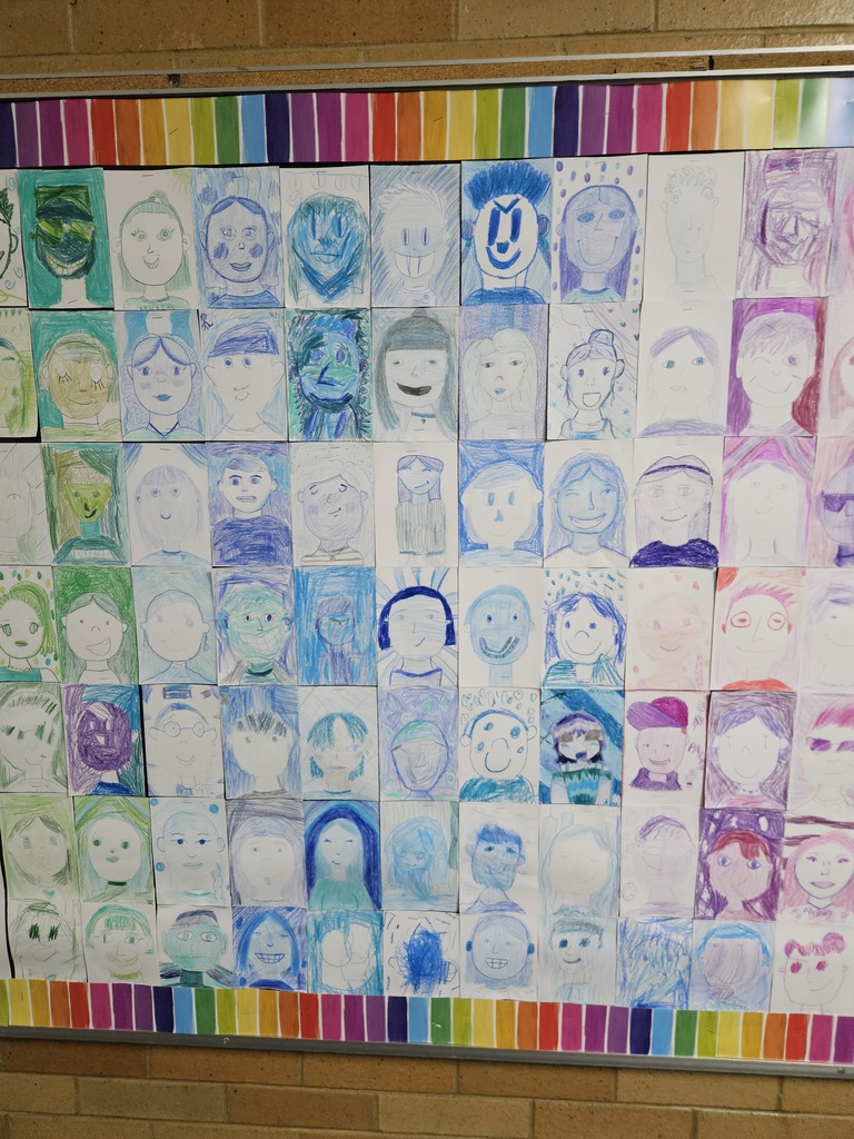 Close-up section of the bulletin board showing self-portraits drawn in shades of blue and indigo.