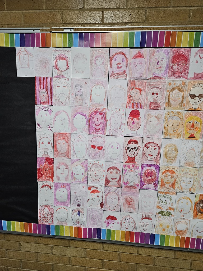 Close-up section of the bulletin board showing self-portraits drawn in shades of pink and red.