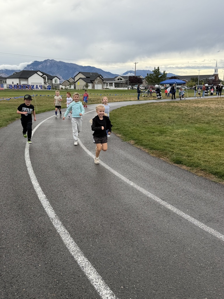 students running and smiling on the track