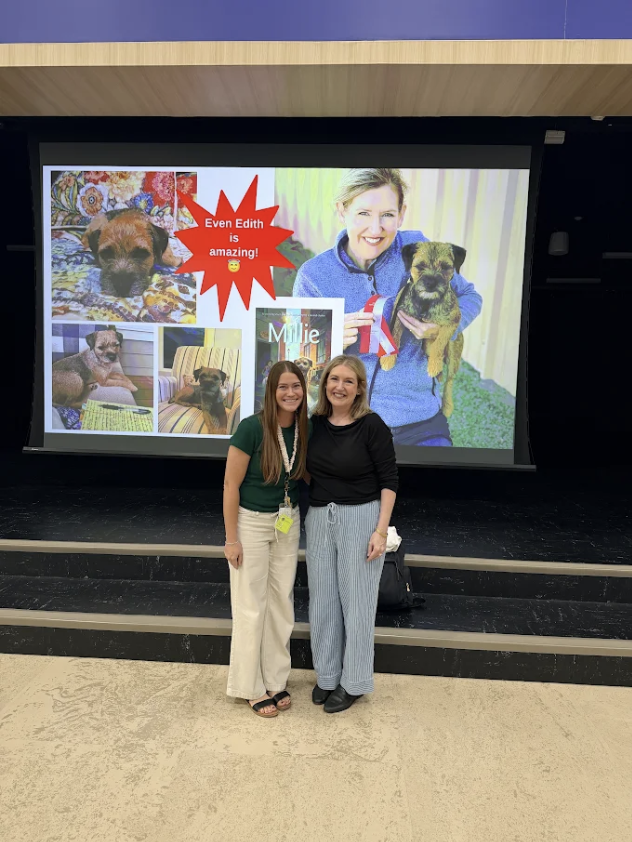 Author McCall Hoyle and Mrs. Ellsworth pose together in front of a stage presentation screen featuring dog photo collages and text that reads "Even Edith is amazing!", "Millie", and "McCall Hoyle".