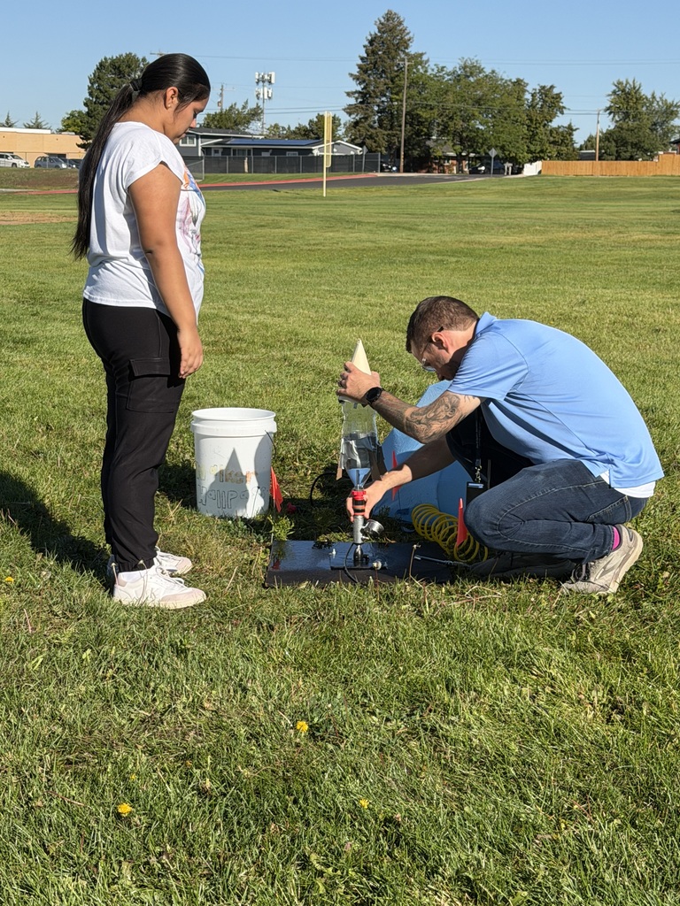 Kid and teacher with home-made rocket