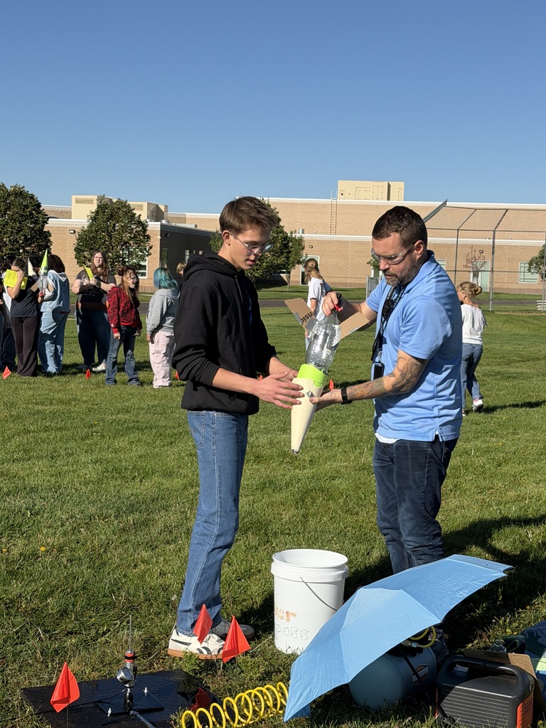 Kid and teacher with home-made rocket