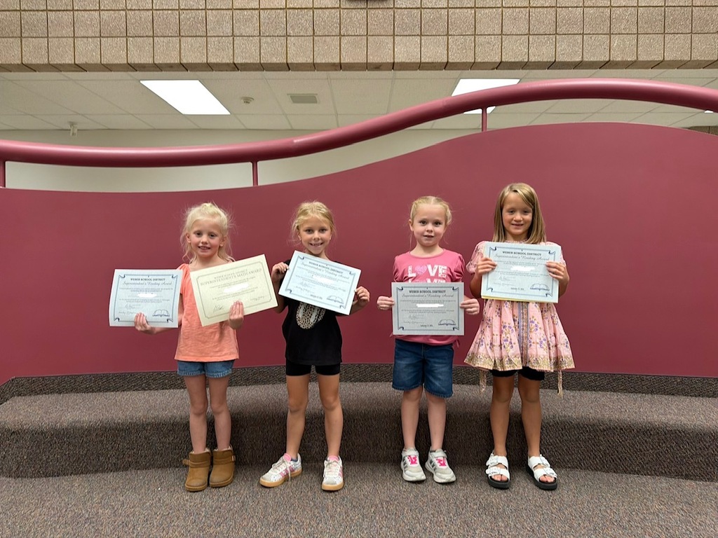 1st grade students smiling with their certificates