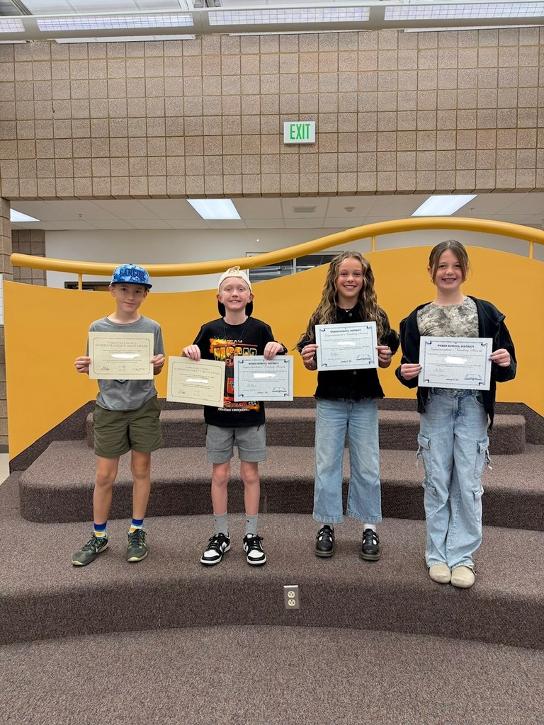 5th grade students smiling with their certificates