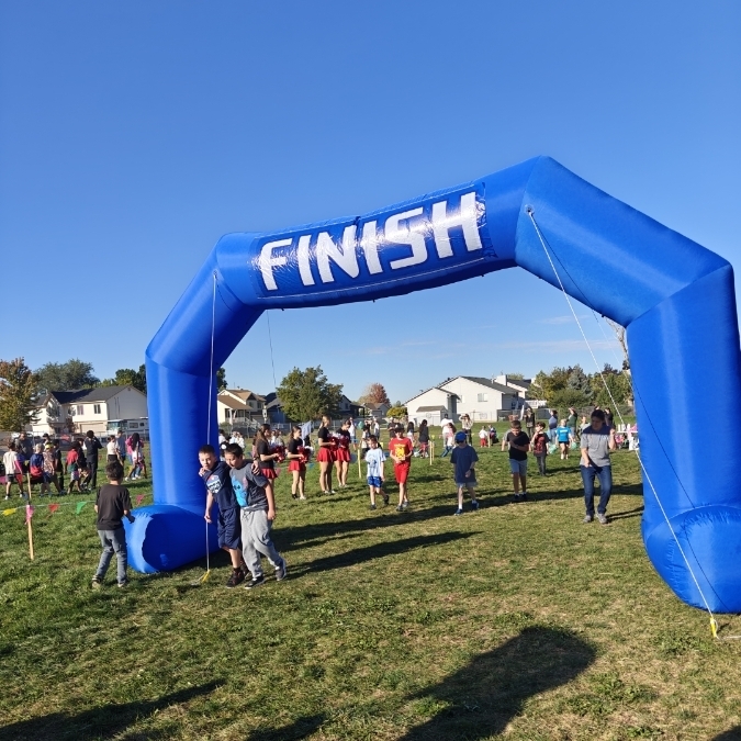 image of finish line with elementary students crossing. 