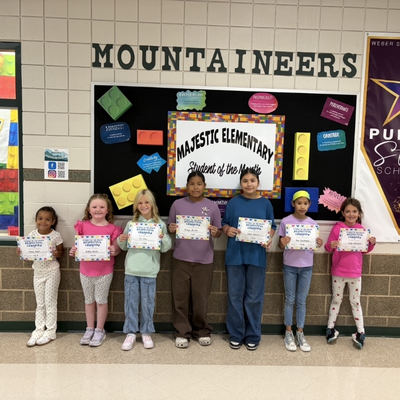 kids holding certificates for student of the month
