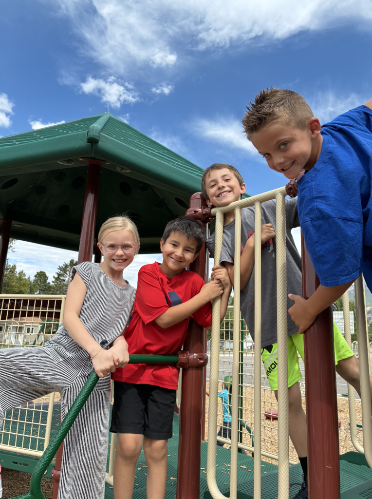 4 kids posing on the playground