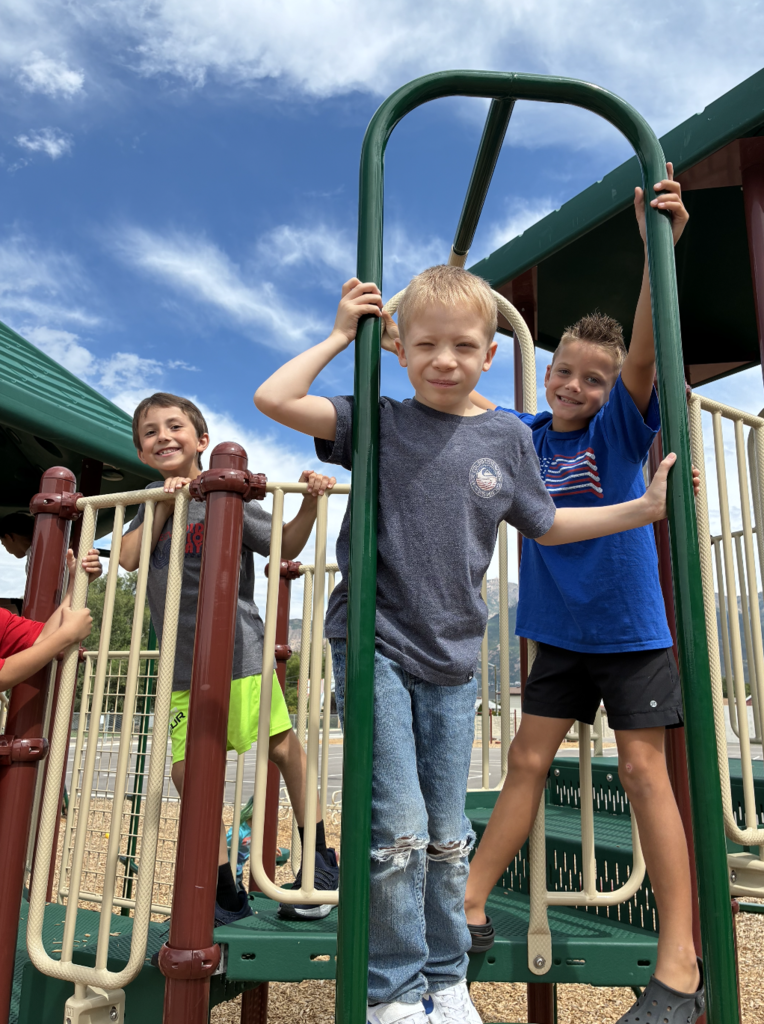 3 boys posing on the playground