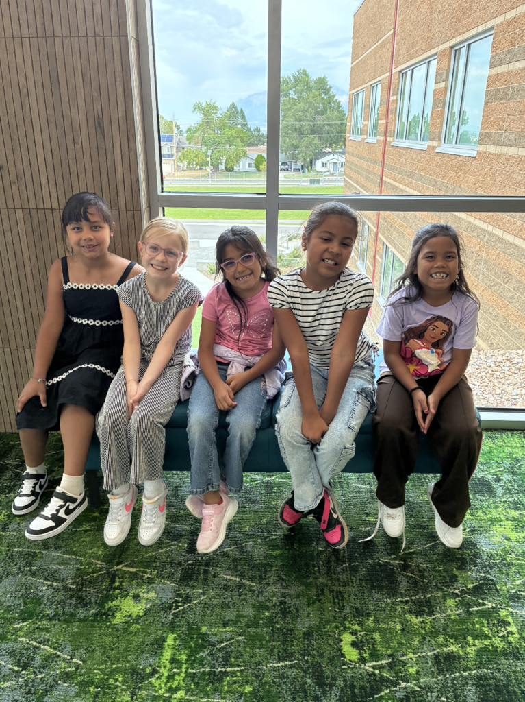5 girls sitting on a bench