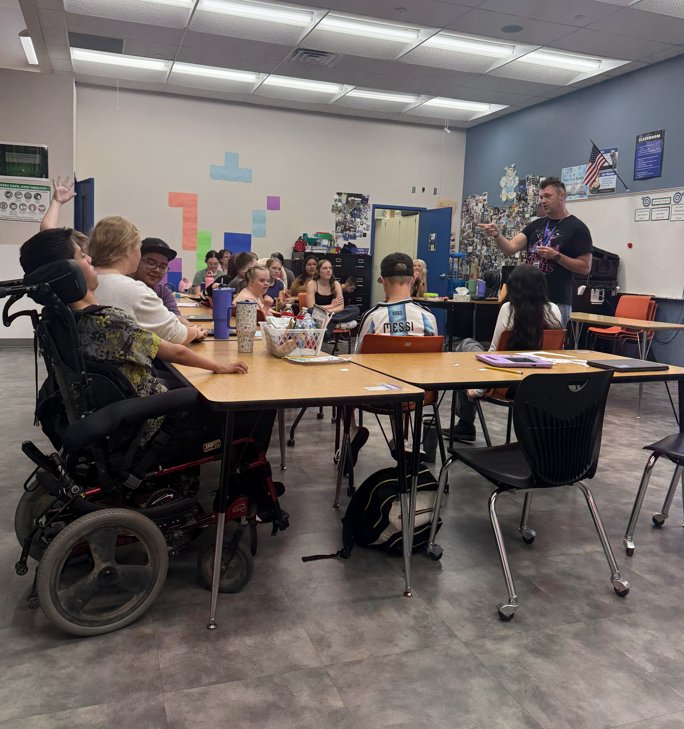 Mr. Evans teaches at the front of the classroom.