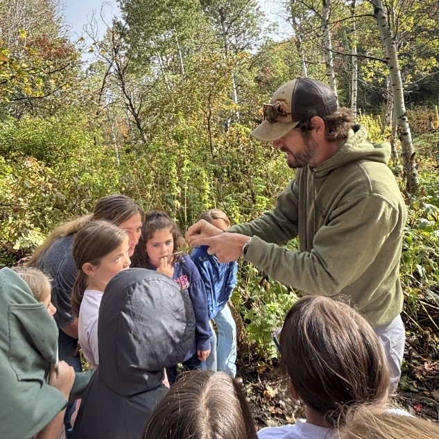 Mr. Parallel showing kids some plants and seeds