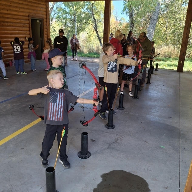 kids shooting bow and arrows