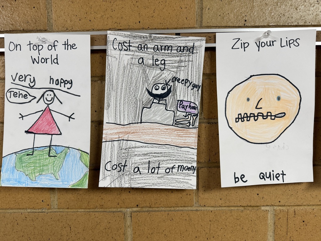 Student drawings illustrating the idioms "On top of the World," "Cost an arm and a leg," and "Zip your Lips."